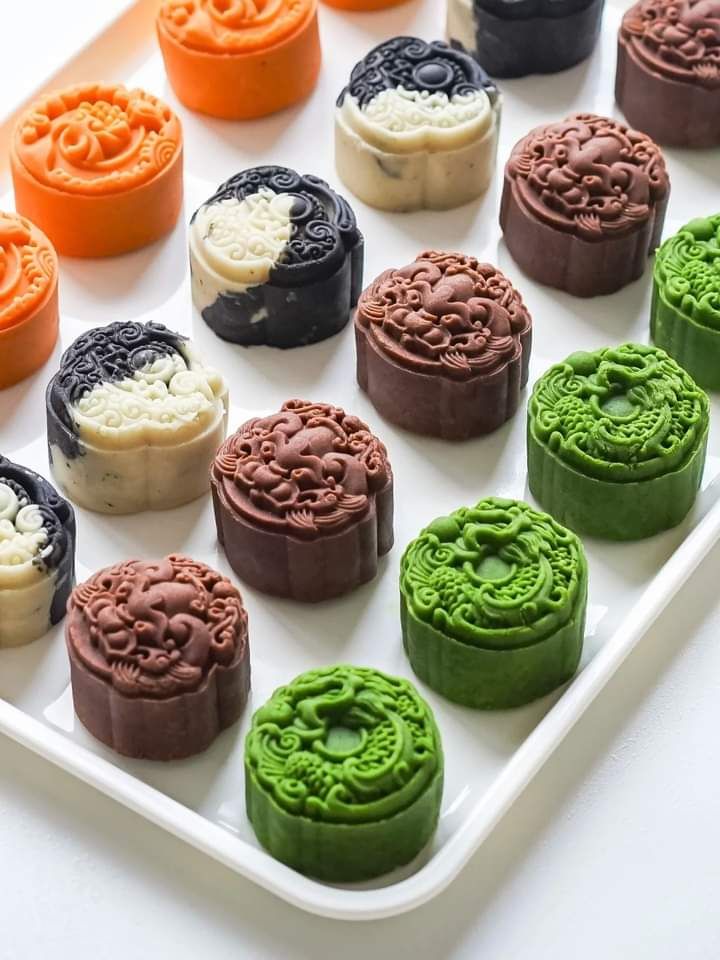 A close-up shot of vibrant green Matcha Mochi Ice Cream bites cut in half, showcasing the soft sweet rice dough and creamy vegan ice cream filling.